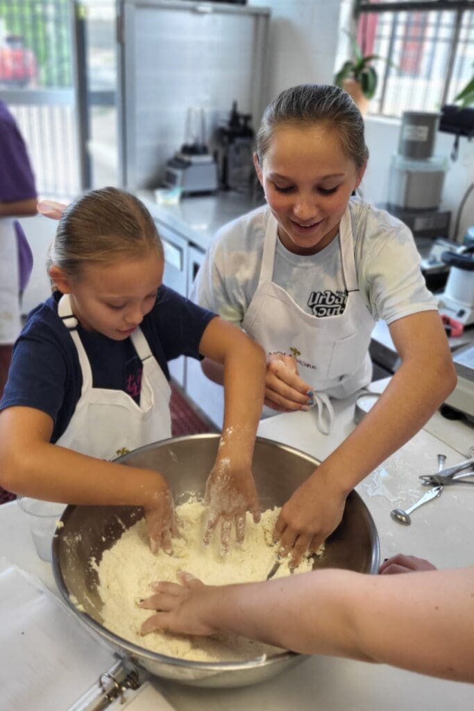 Nolavore campers mix dry ingredients in large bowl