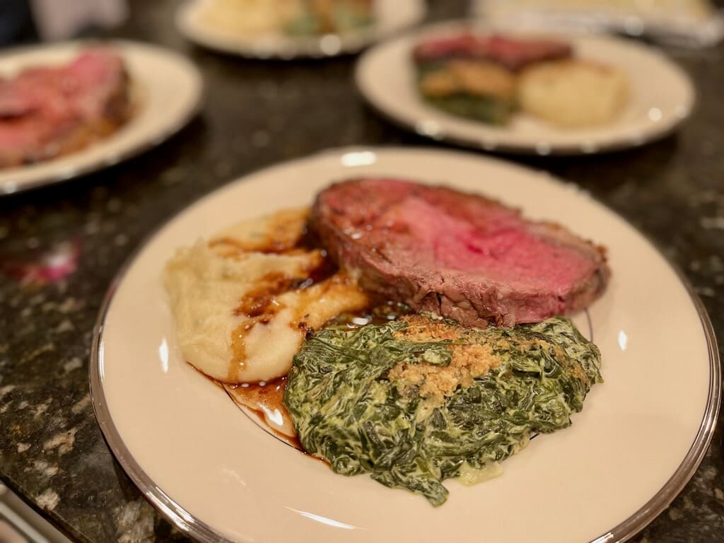 Seated dinner plate with spinach, beef, and mashed potatoes